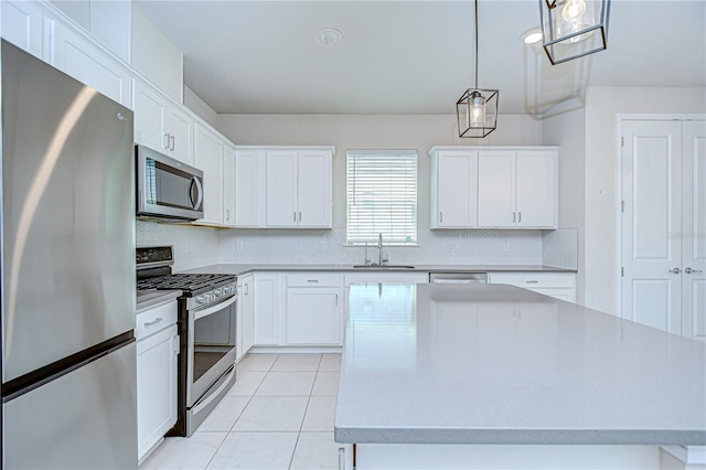17805 Everlong Dr, Land O Lakes, FL 34638 - kitchen with stainless steel appliances, tasteful backsplash, light countertops, and white cabinetry