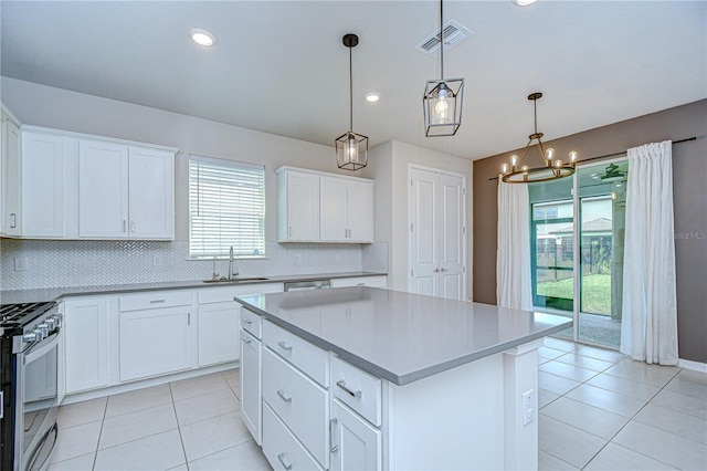 17805 Everlong Dr, Land O Lakes, FL 34638 - kitchen featuring stainless steel gas range, backsplash, a chandelier, light tile patterned floors, and recessed lighting