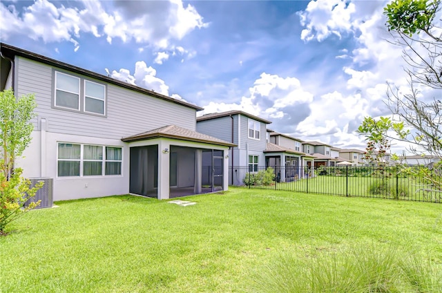 17805 Everlong Dr, Land O Lakes, FL 34638 - back of house featuring a fenced backyard, a sunroom, and a residential view
