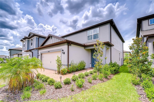 17805 Everlong Dr, Land O Lakes, FL 34638 - view of front facade featuring stucco siding, a garage, and a front yard