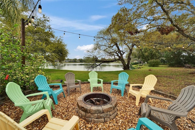 view of patio / terrace featuring a water view and an outdoor fire pit