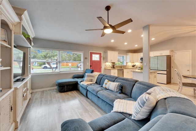 living area featuring lofted ceiling, light wood-style flooring, recessed lighting, and ceiling fan