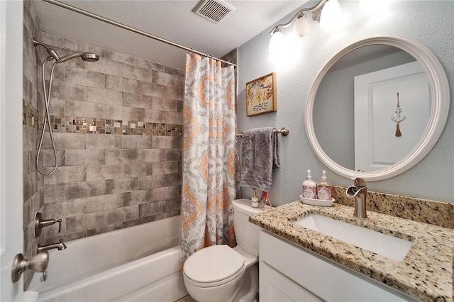 bathroom featuring visible vents, shower / bath combo with shower curtain, toilet, vanity, and a textured wall