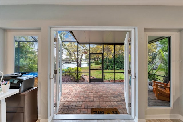 entryway featuring brick floor and a sunroom