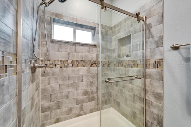 full bath featuring a shower stall