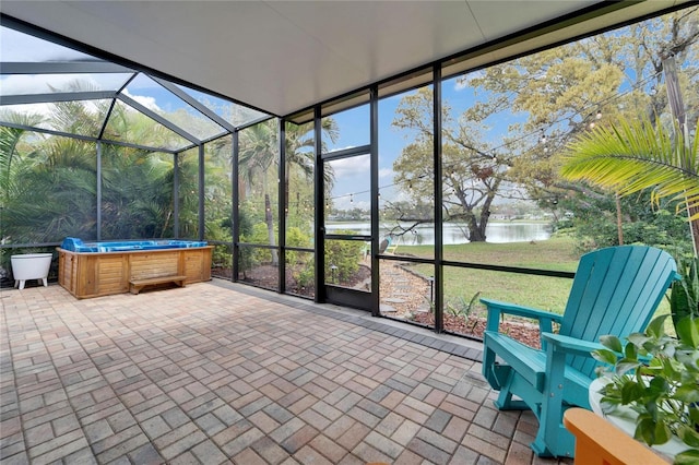 unfurnished sunroom with plenty of natural light and a water view