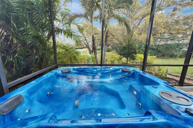 view of pool with a lanai and a hot tub