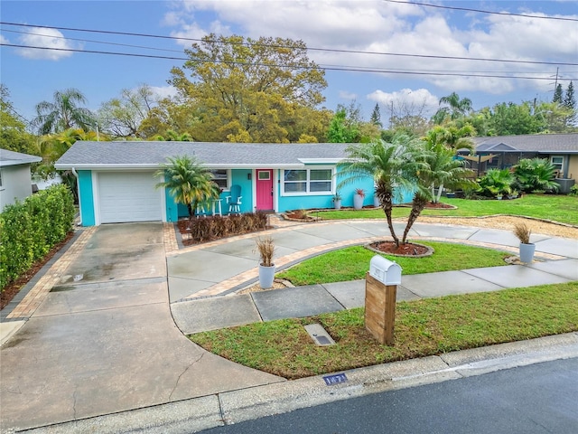 single story home featuring a garage, stucco siding, driveway, and a front yard