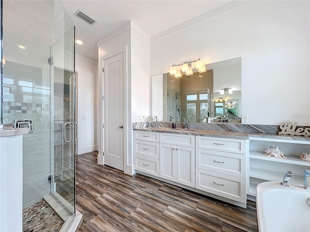 bathroom with vanity, a bathtub, a shower stall, and visible vents