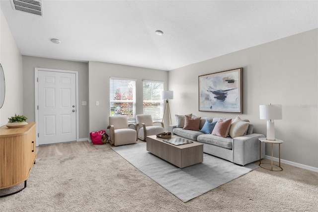 carpeted living area with visible vents and baseboards