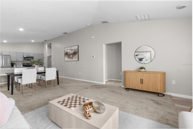 living room featuring lofted ceiling, recessed lighting, light colored carpet, visible vents, and baseboards