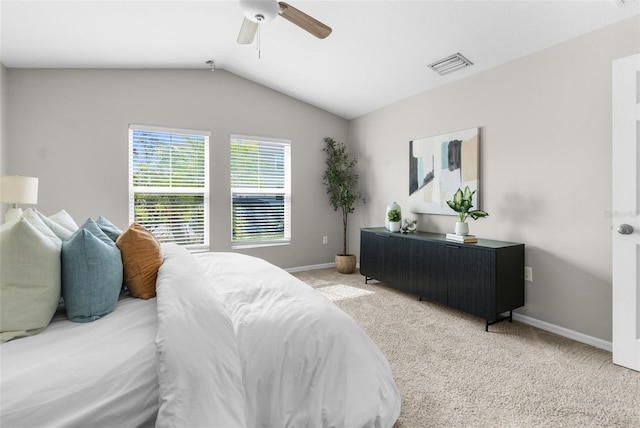 carpeted bedroom with vaulted ceiling, a ceiling fan, visible vents, and baseboards