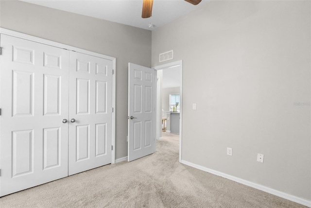 unfurnished bedroom with baseboards, visible vents, ceiling fan, carpet flooring, and a closet