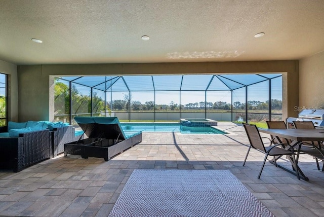 view of swimming pool featuring a pool with connected hot tub, a lanai, outdoor lounge area, and a patio