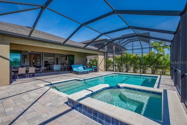 view of swimming pool featuring a patio area, a pool with connected hot tub, and an outdoor living space