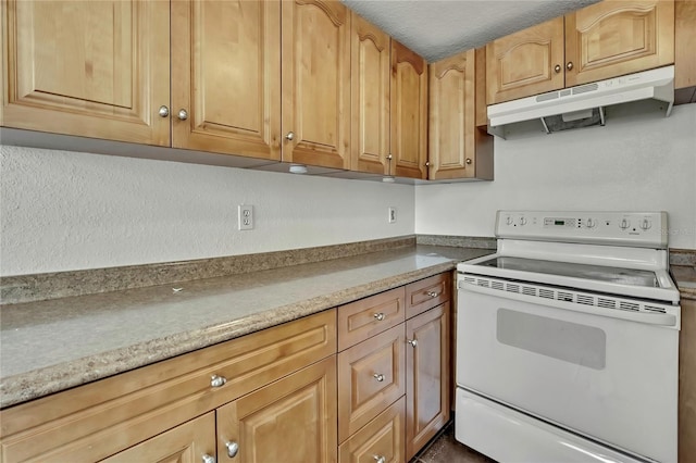 kitchen featuring light countertops, under cabinet range hood, and white range with electric cooktop