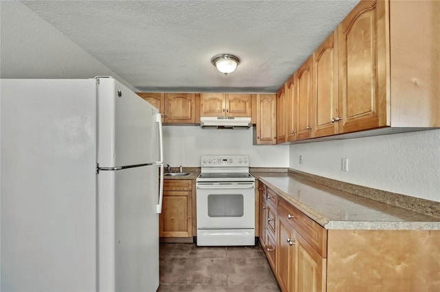 kitchen with a textured ceiling, under cabinet range hood, white appliances, a sink, and light countertops