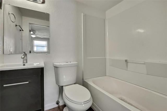 full bathroom with baseboards, vanity, toilet, and shower / bathtub combination