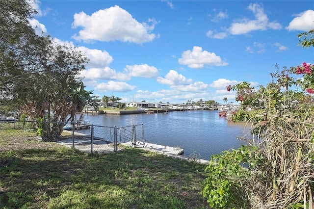 view of water feature featuring a dock and fence