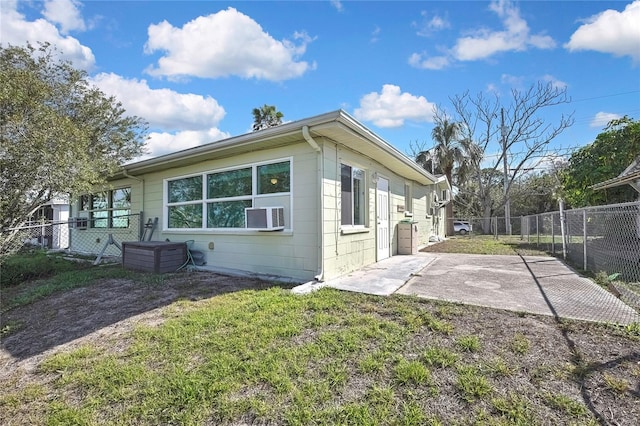 view of side of home featuring a yard, cooling unit, fence, and a patio