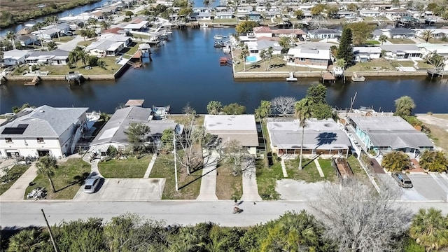 drone / aerial view with a water view and a residential view