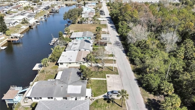 drone / aerial view with a water view and a residential view