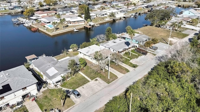 birds eye view of property with a water view and a residential view