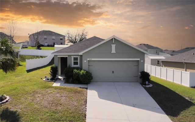 view of front of property with concrete driveway, a lawn, an attached garage, and stucco siding