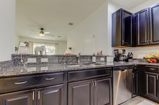 kitchen with a sink, dark stone countertops, visible vents, and dishwasher