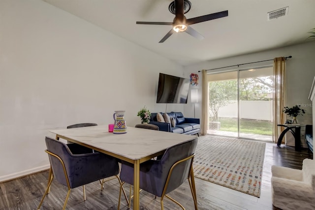 dining room featuring baseboards, wood finished floors, visible vents, and a ceiling fan