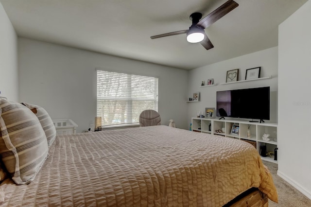 carpeted bedroom with a ceiling fan and baseboards