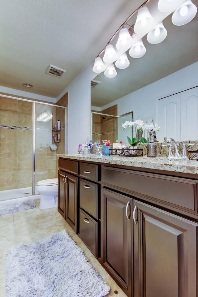 full bathroom featuring toilet, a shower stall, visible vents, and vanity