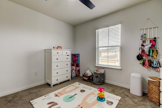 playroom featuring carpet floors, baseboards, and a ceiling fan