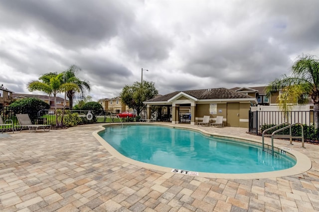 pool featuring a patio area and fence