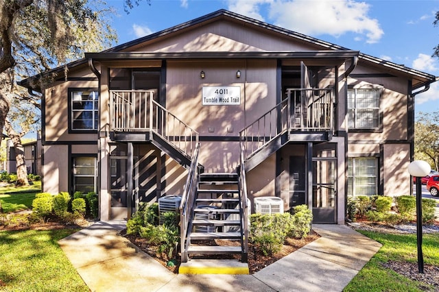 view of front of home with central air condition unit and stairs