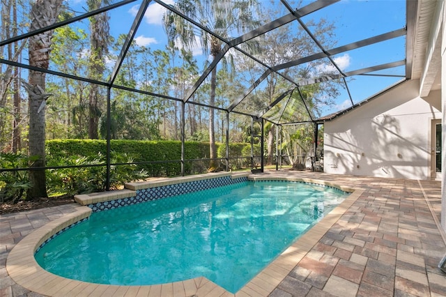 outdoor pool with glass enclosure and a patio area