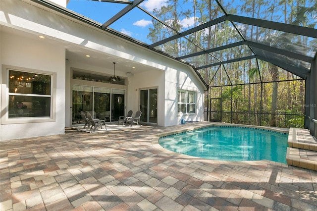 pool featuring a lanai, a patio area, and ceiling fan