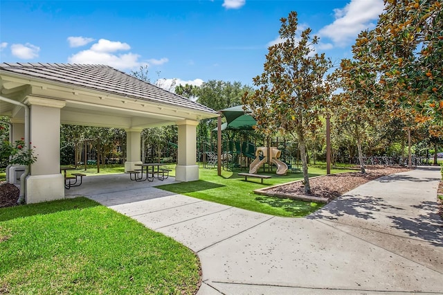 view of community with a gazebo, playground community, and a yard