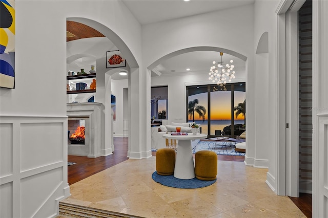 interior space featuring recessed lighting, a decorative wall, and a multi sided fireplace