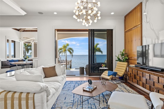 living area with a chandelier, ornamental molding, wood finished floors, and recessed lighting