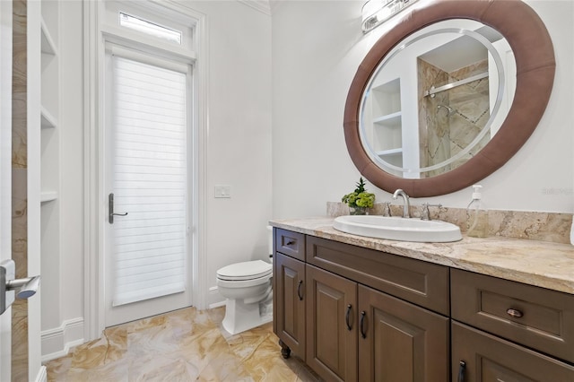 bathroom featuring a shower, vanity, and toilet