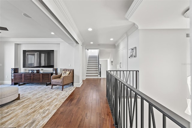 hall featuring dark wood-style floors, ornamental molding, and baseboards