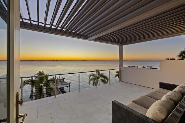 view of patio / terrace featuring a water view and a balcony