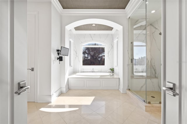 bathroom with a garden tub, baseboards, a marble finish shower, and ornamental molding