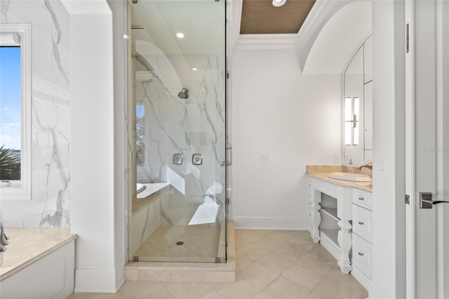 bathroom featuring baseboards, crown molding, vanity, and a marble finish shower