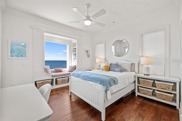 bedroom featuring ceiling fan, dark wood-type flooring, a water view, and crown molding