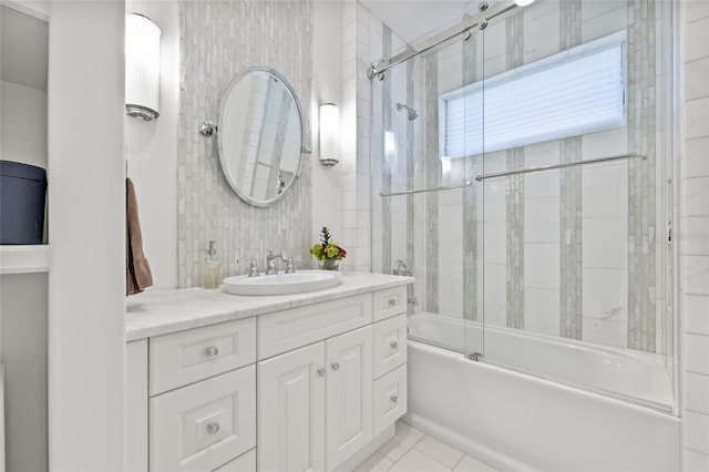 bathroom featuring combined bath / shower with glass door, vanity, and tile patterned floors