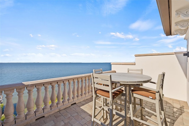 exterior space featuring outdoor dining area and a water view