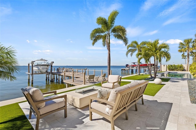 view of patio featuring a dock, a water view, boat lift, and an outdoor pool