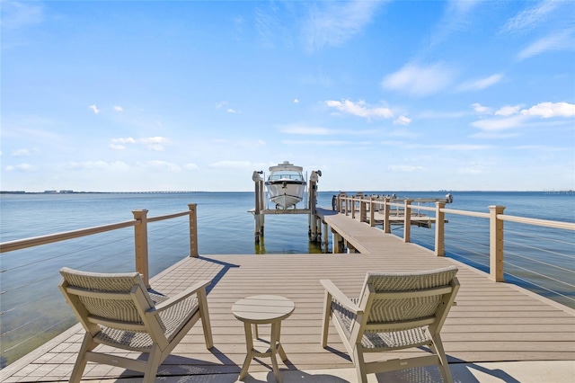 dock area with a water view and boat lift